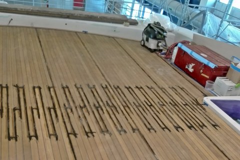Gluing teak deck panels on yacht by Duca Solutions