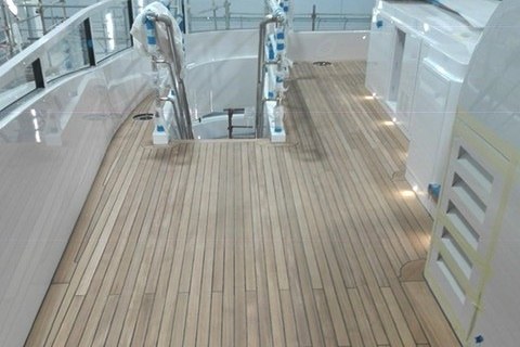 Teak deck fitting on a motor yacht by Duca Solutions