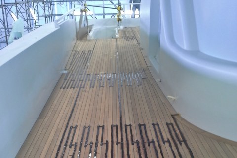 Vacuum gluing teak deck panels on mega yacht by Duca Solutions