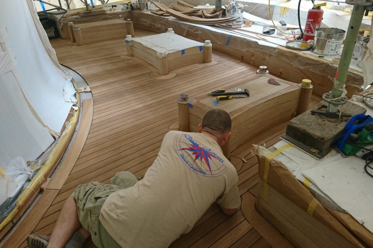 Refinishing teak decks on motor yacht Duca Solutions